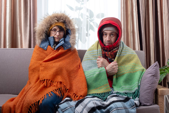 couple bundling up in a heating emergency