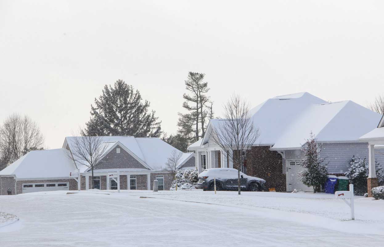 a home covered in snow in Wisconsin, demonstrating the need to winterize your home