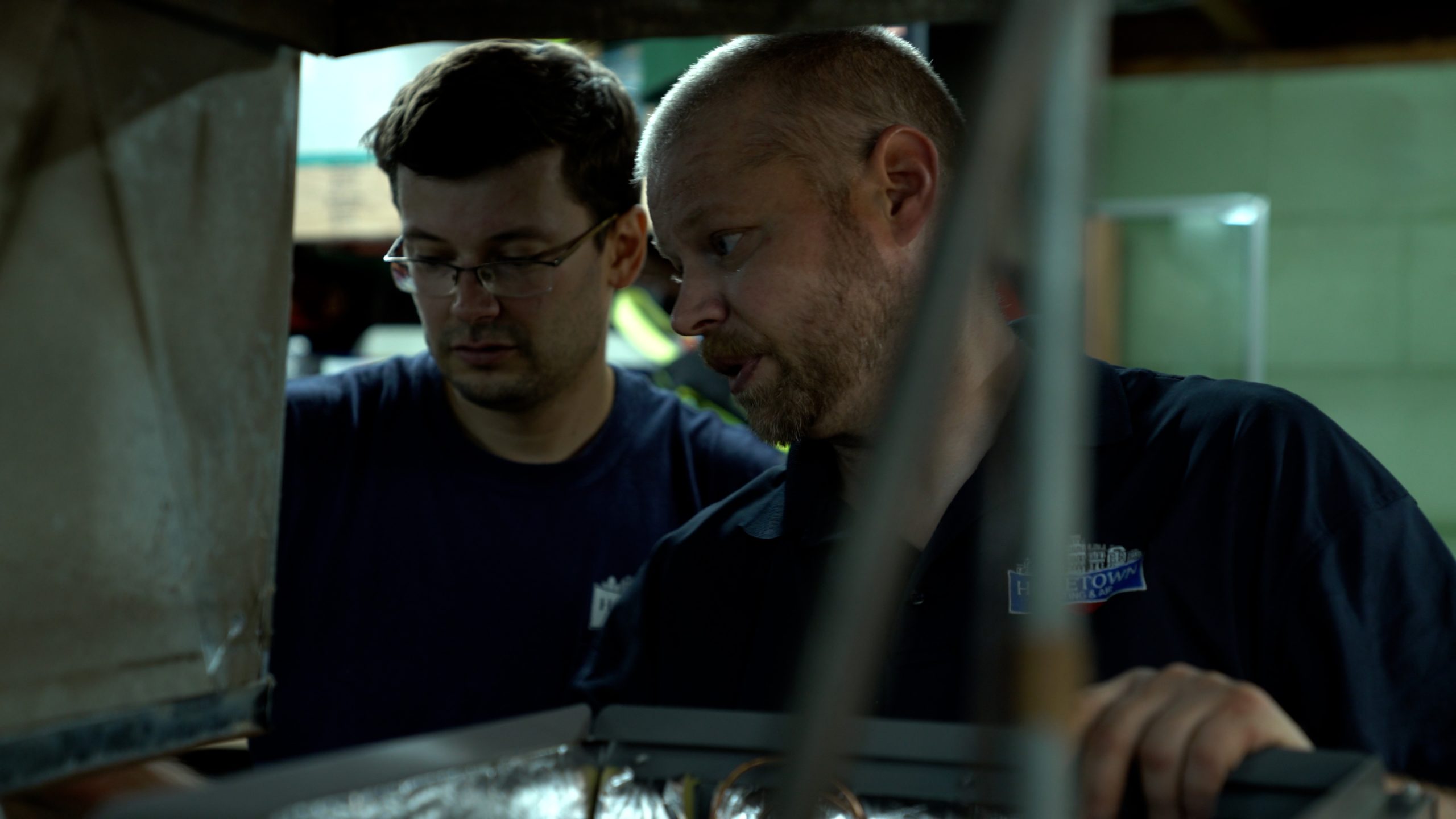 Maintenance workers from Hometown Heating, Air & Electric performing furnace tune-ups in people's homes